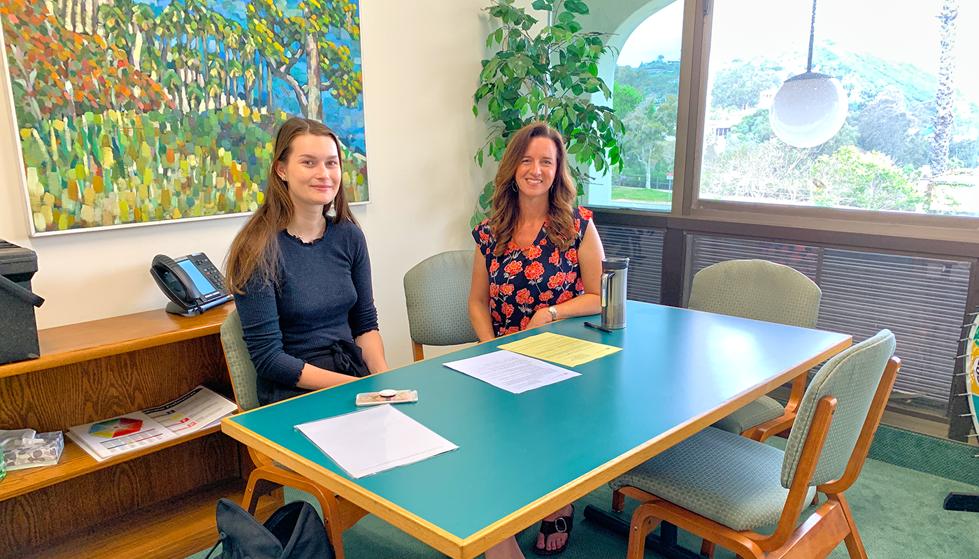 Career counselor at table with student and her assessments